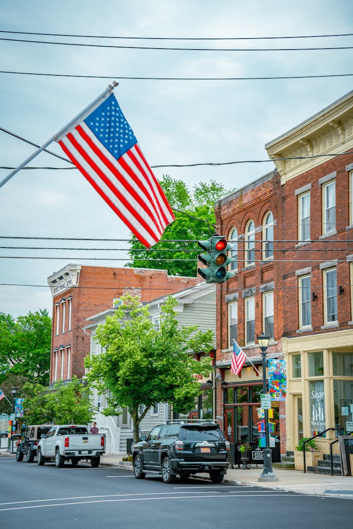 Charming small-town street scene in America with flags and classic architecture.